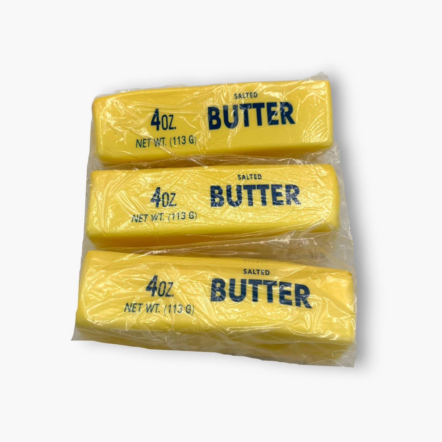 Three packages of 4oz salted butter on a white background