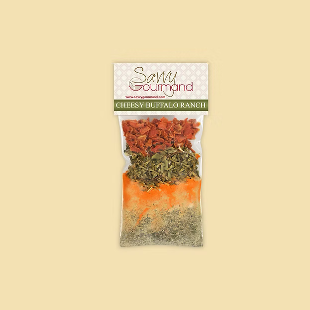 Savvy Gourmand Cheesy Buffalo Ranch seasoning mix packaging on a beige background