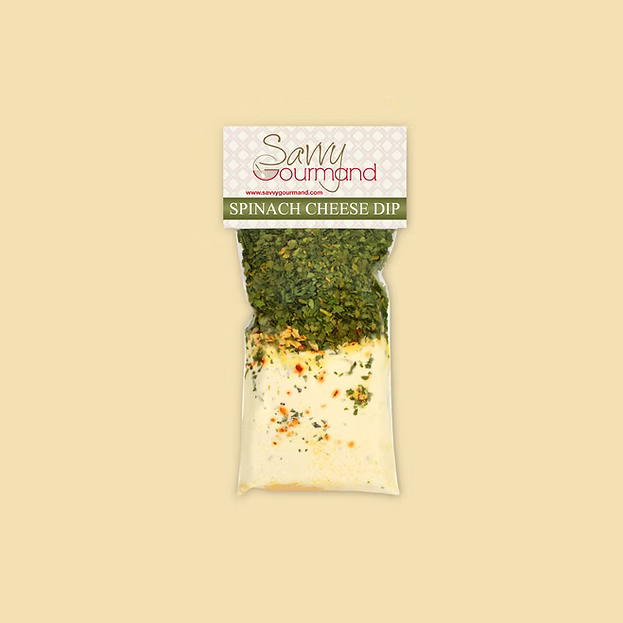 Packaged spinach cheese dip with Savvy Gourmand label on a beige background