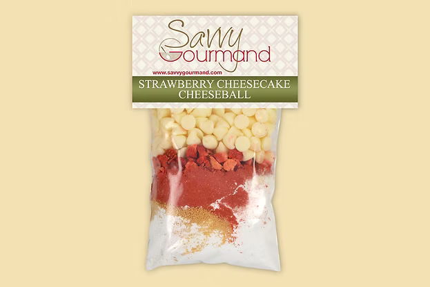 Package of Savvy Gourmand strawberry cheesecake cheeseball mix on a beige background