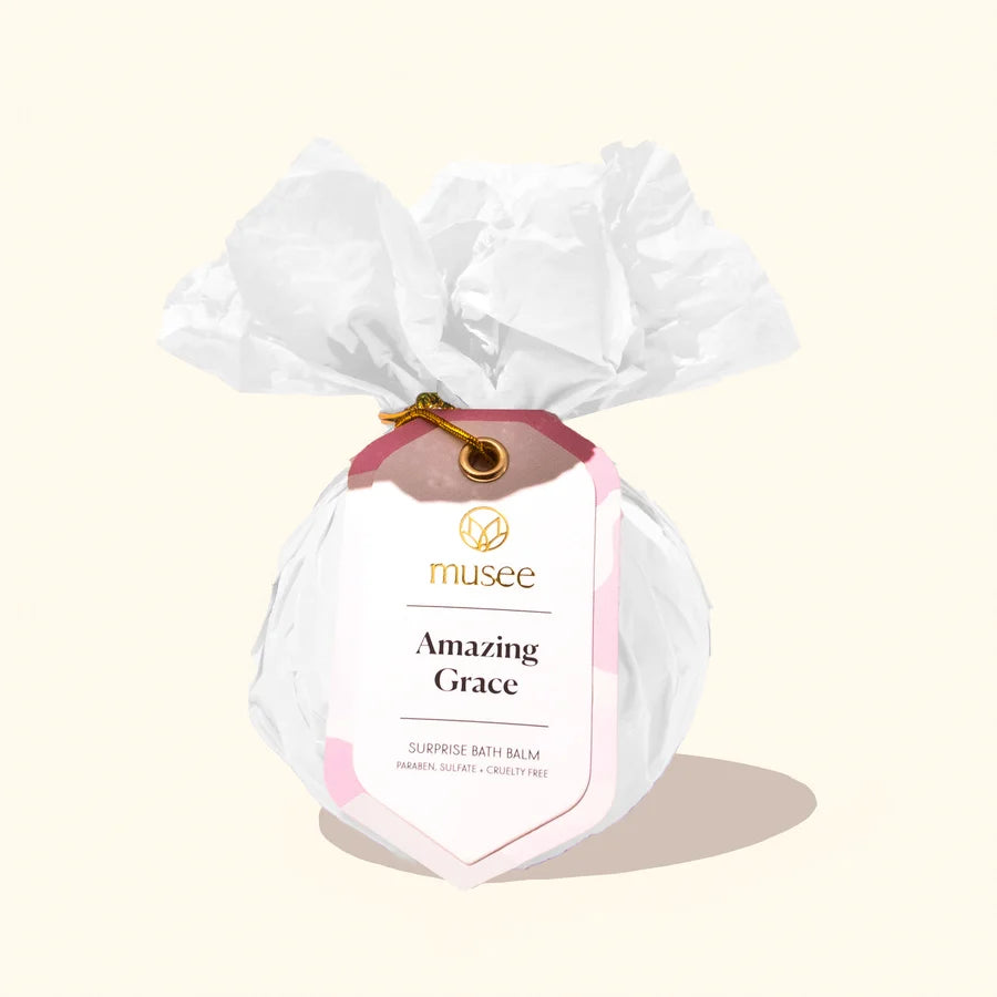 Bath balm with 'musee' branding and 'Amazing Grace' text on a light beige background