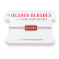A gold beaded bracelet with a red rectangular charm reading 'RollTide' in white script, displayed on a white jewelry card labeled 'BEADED BLONDES 14 K GOLD FILLED JEWELRY'.