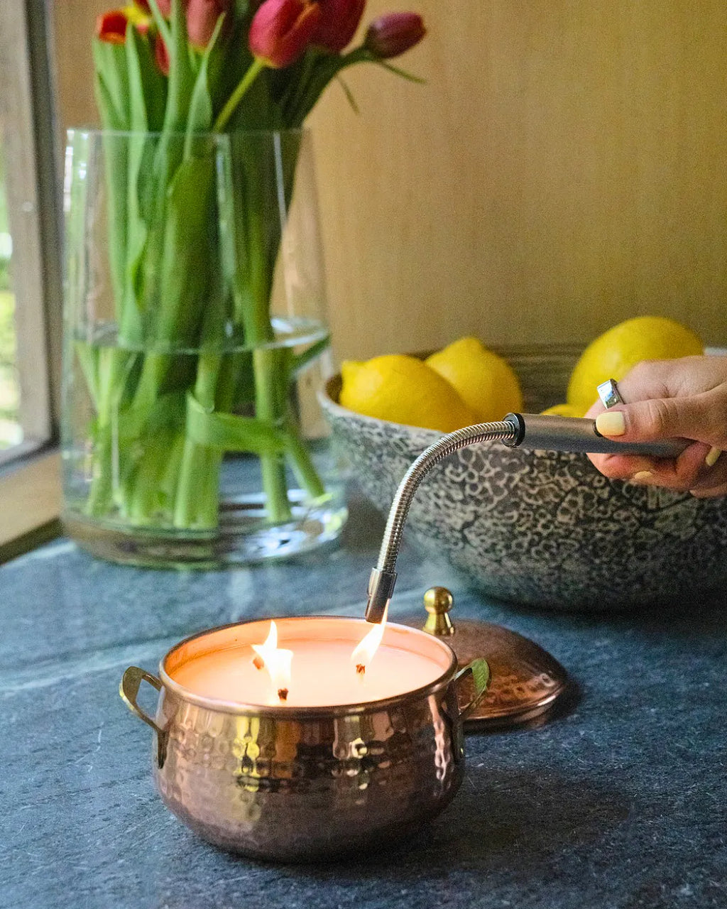 Copper pot three-wick candle with warm simmered cider fragrance featuring apple, clove, and cardamom notes