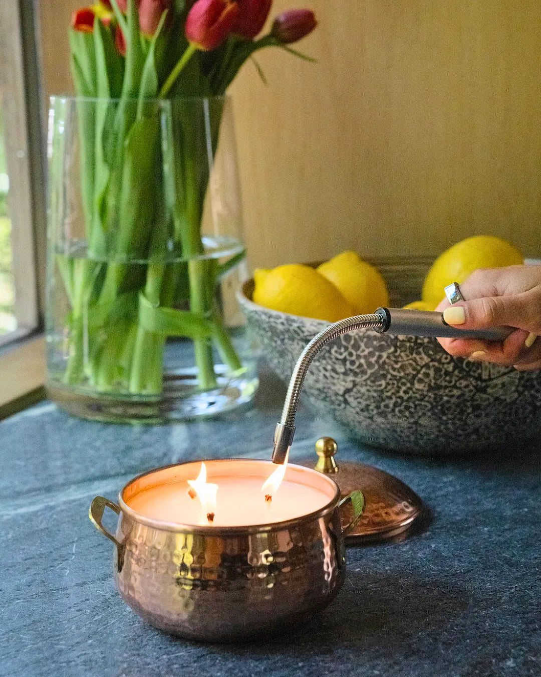 Copper pot three-wick candle with warm simmered cider fragrance featuring apple, clove, and cardamom notes