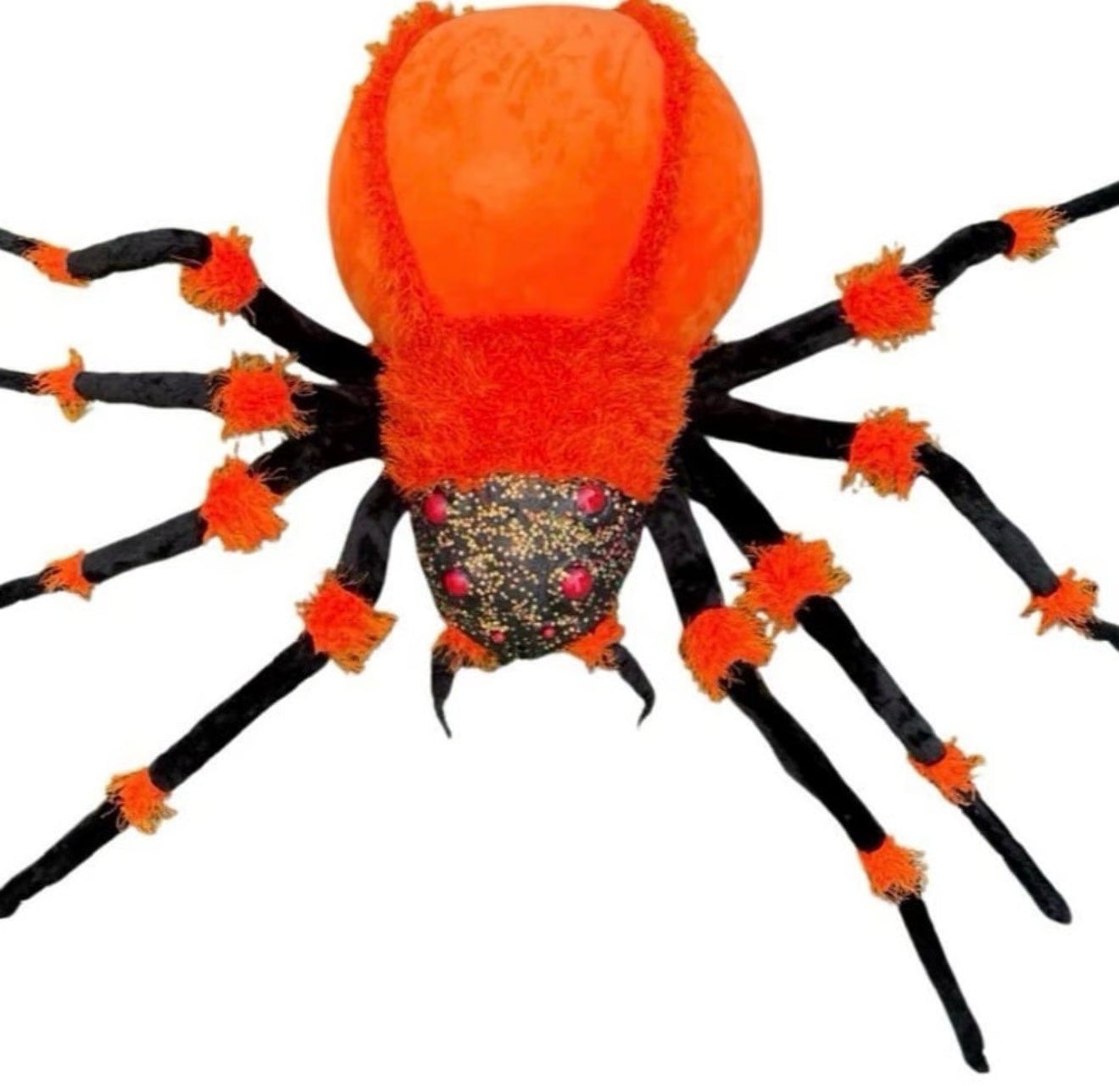 A plush spider toy with a bright orange fuzzy body and black legs, accented with orange pom-poms and small pink rhinestones on the abdomen, shown against a plain white background.