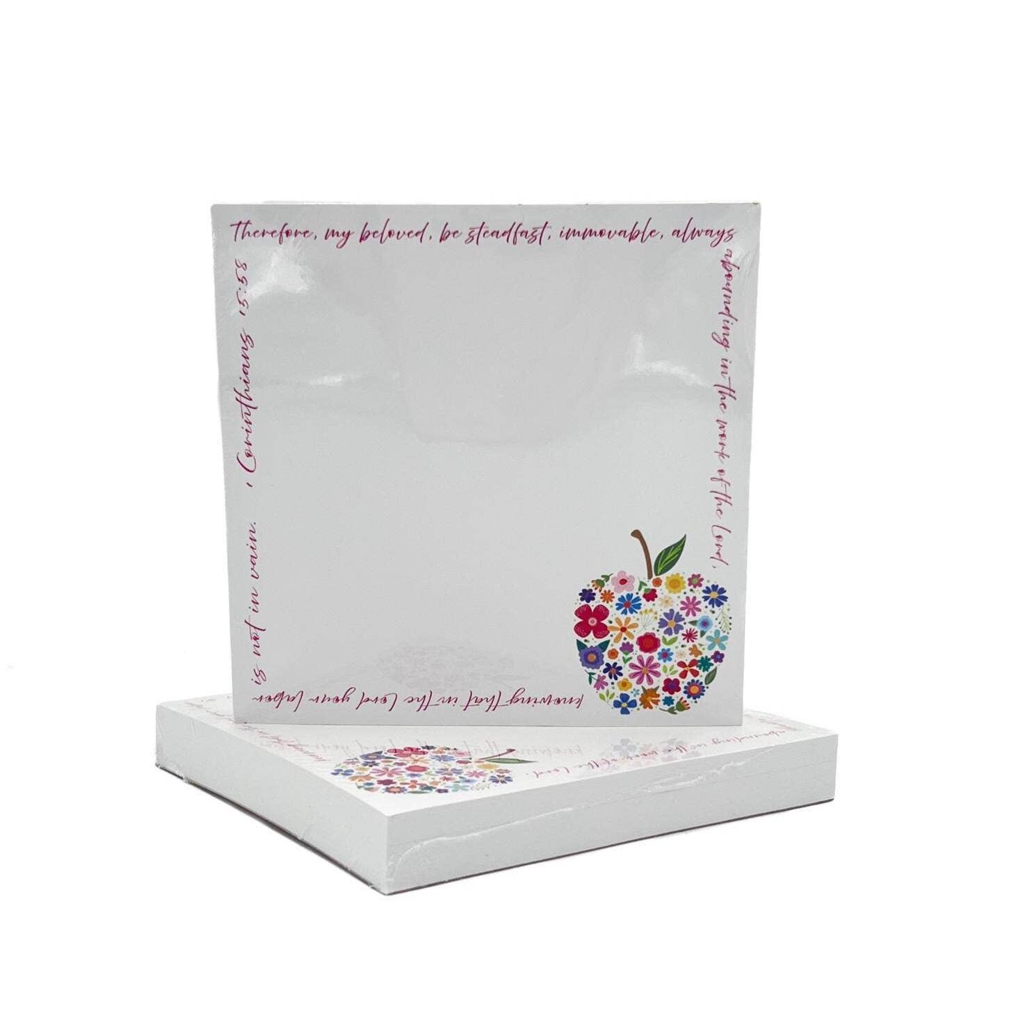 Decorative notepad with floral apple design and text on a white background