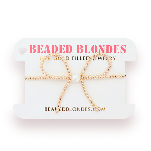Gold beaded bow-shaped earrings on a 'Beaded Blondes' branded card.