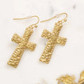 Matte gold hammered cross dangle earrings with textured finish