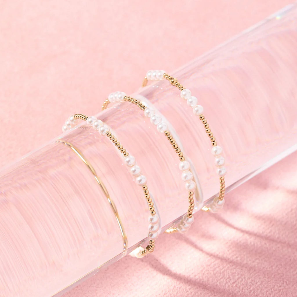 Set of pearl headbands on a pink background