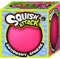 A boxed toy product labeled 'Squish Attack' with a bright pink squooshy sphere visible through the front packaging window. The box is lime green and blue with large product branding and '1 PC' text.