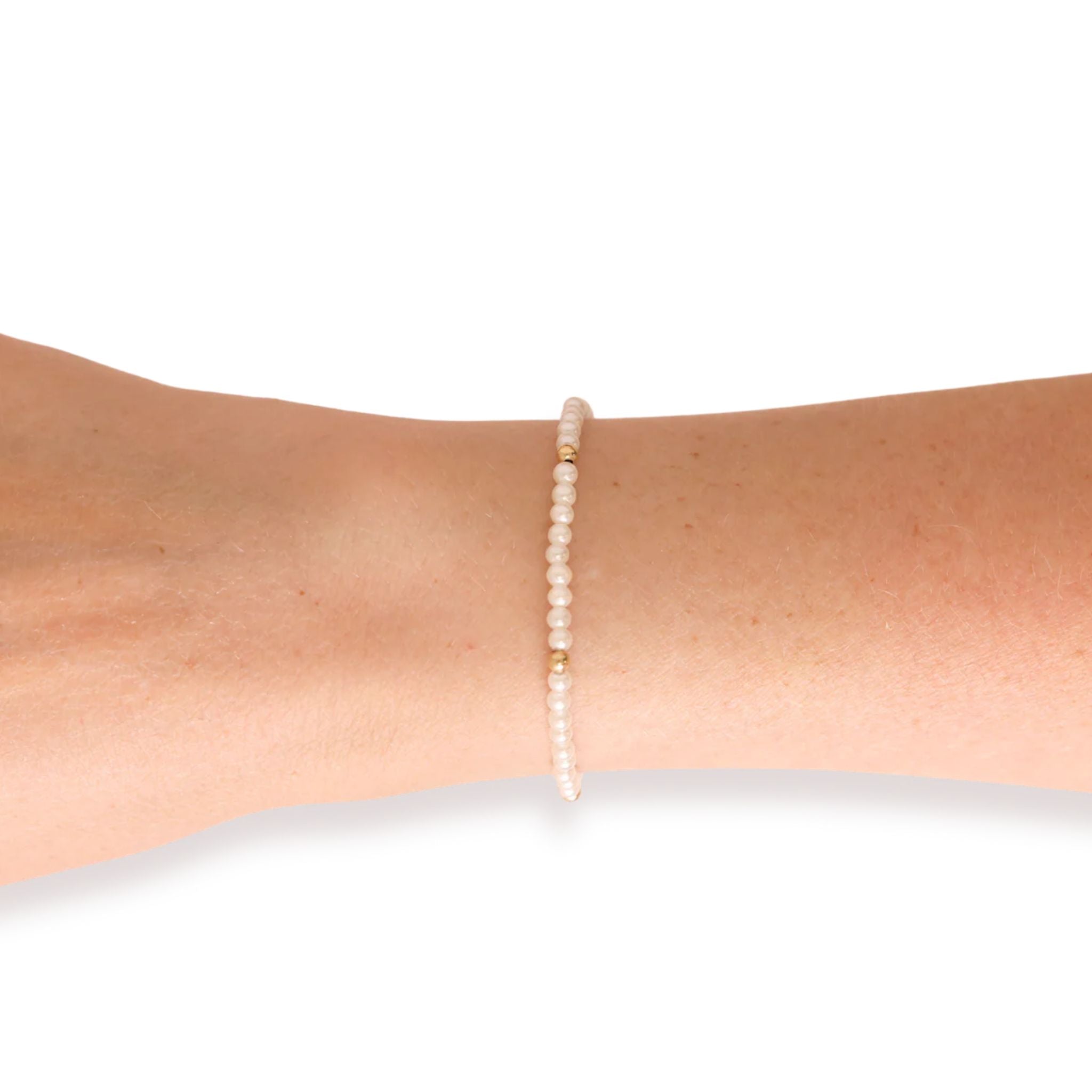 Pearl bracelet on a wrist against a white background
