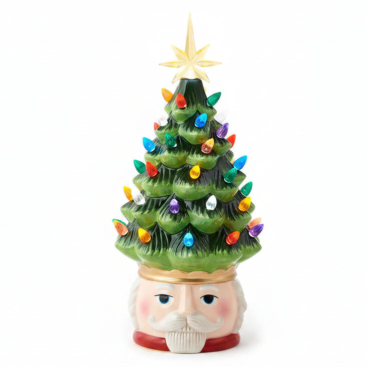 Three small ceramic Christmas tree figurines on a light gray background: one with a snowman head, one with a Santa Claus face in the middle, and one with a Santa Claus face on the right. The trees are green with multicolored lights and gold star toppers.