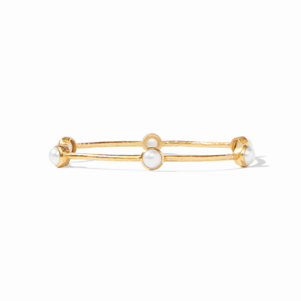 Gold bracelet with pearl-like beads on a white background