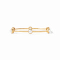 Gold bracelet with pearl-like beads on a white background