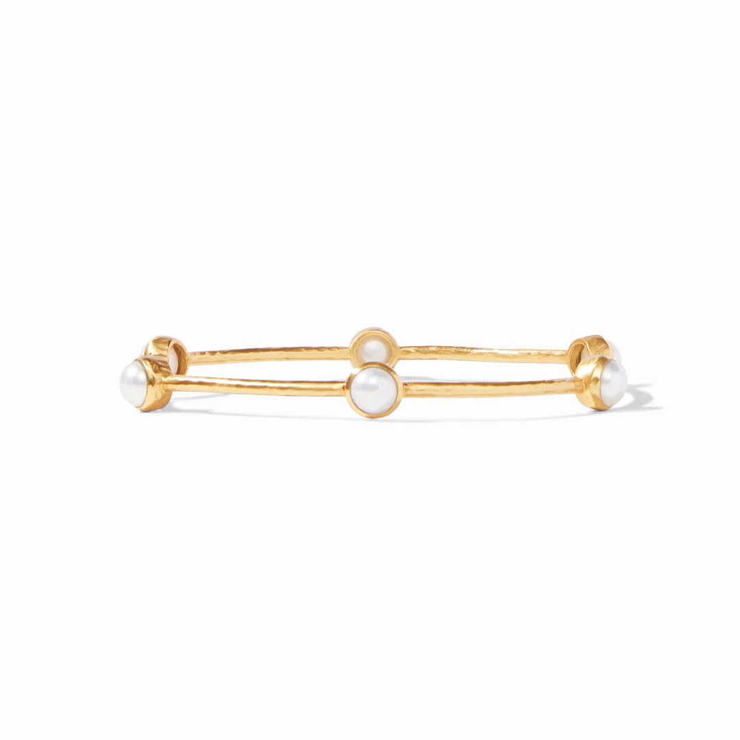 Gold bracelet with pearl-like beads on a white background