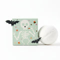 Halloween-themed soap with packaging featuring a skeleton and bats on a white background