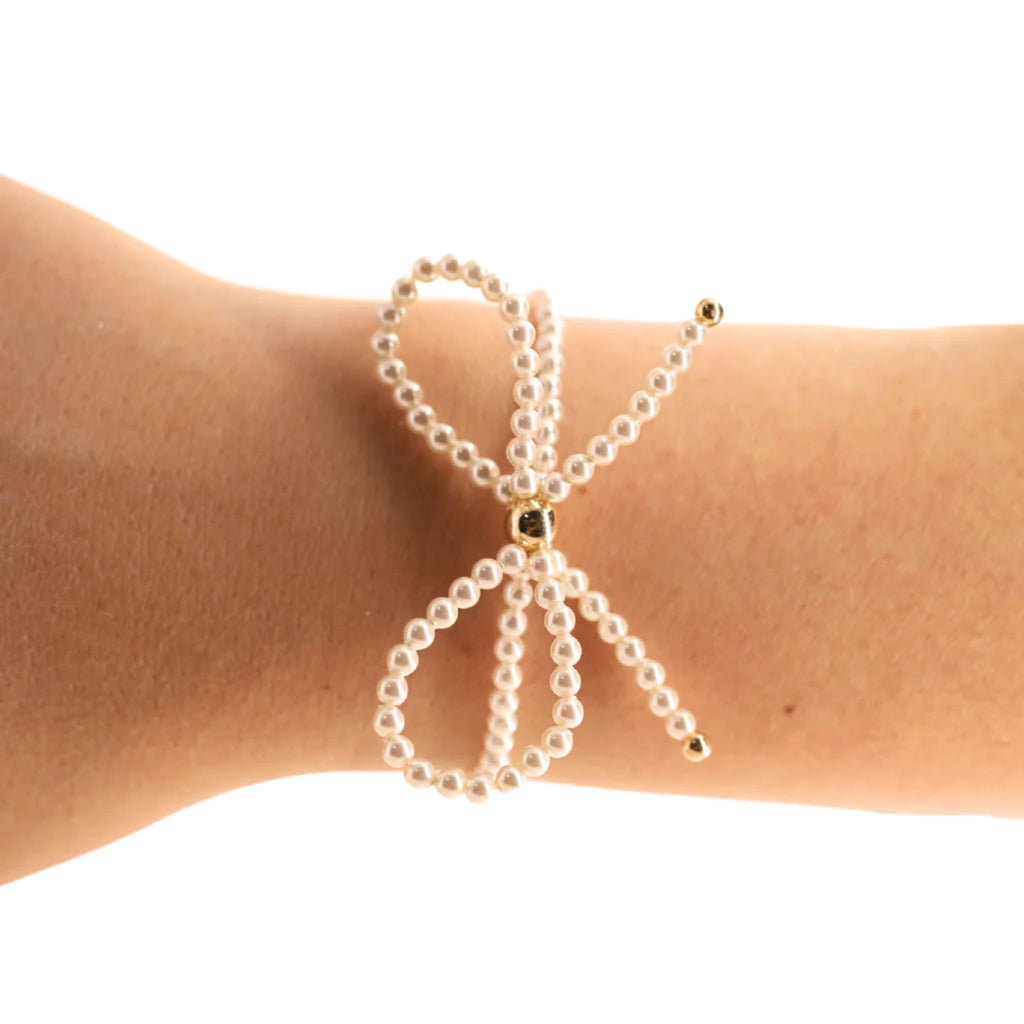Pearl bracelet on a wrist against a white background