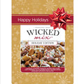 Wicked Mix Holiday Edition snack bag by Moonlight Mixes, featuring a festive gold background with snowflakes, a red 'Happy Holidays' banner, a large red bow graphic, and a photo of the cashew almond pecan chocolate snack mix on the front.