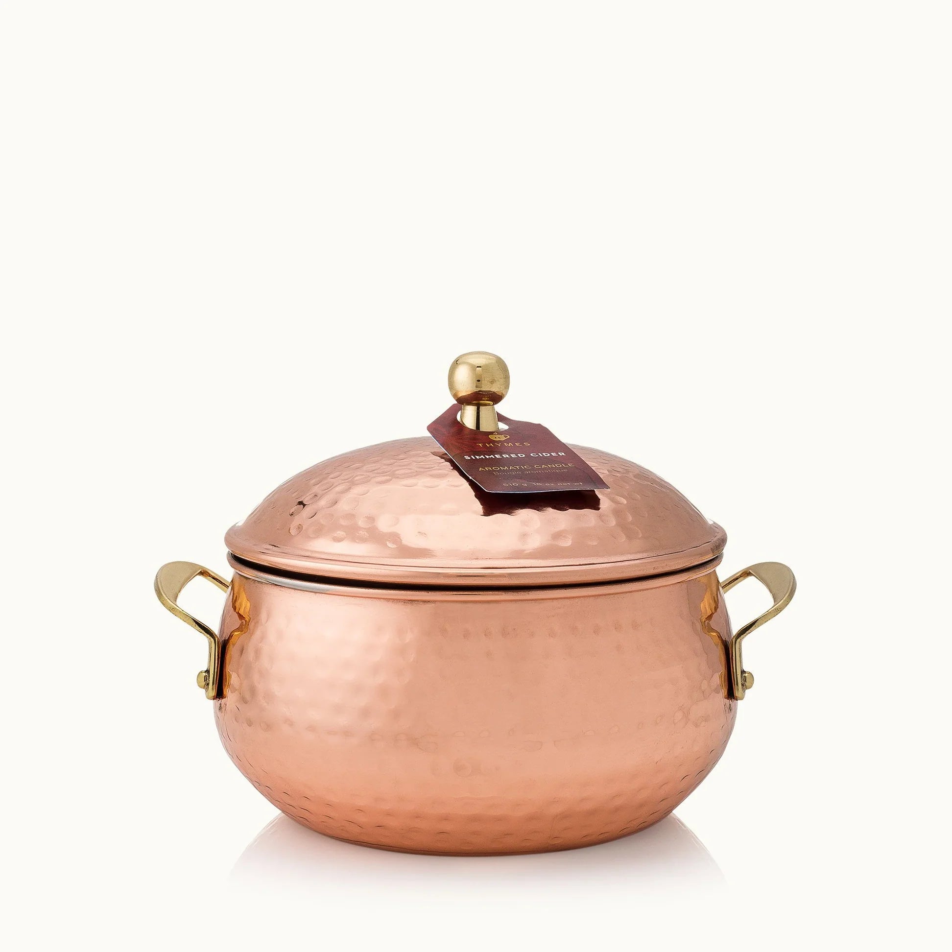 Copper pot with a lid on a white background